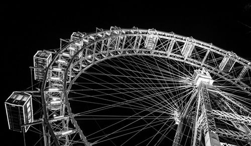 Low angle view of ferris wheel at night