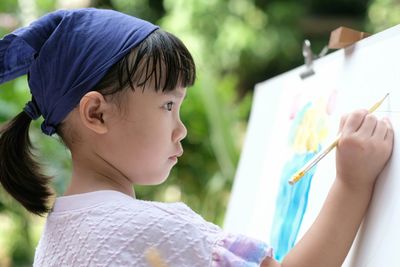 Portrait of boy holding baby hand