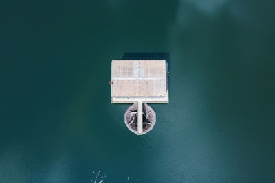 High angle view of information sign on lake against wall