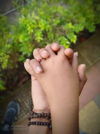 Close-up of couple holding hands