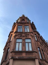 Low angle view of old building against blue sky