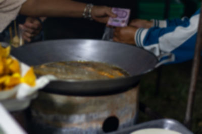 Close-up of person preparing food in kitchen