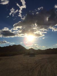 Scenic view of mountains against cloudy sky