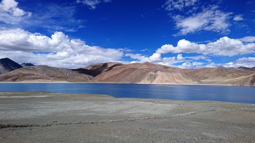 Scenic view of mountains against cloudy sky