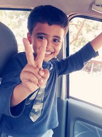 Portrait of boy smiling in car