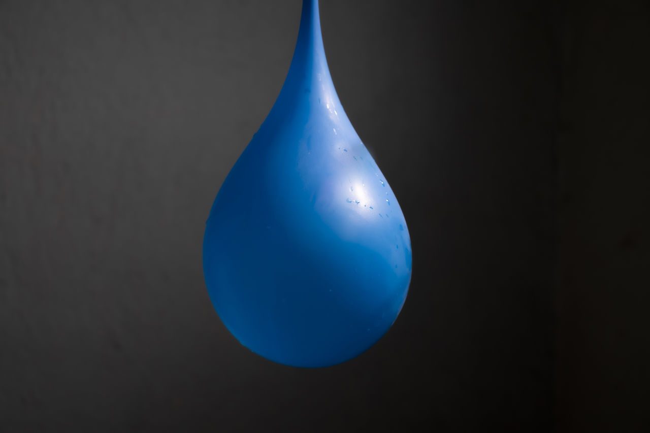 CLOSE-UP OF BALLOON AGAINST BLUE BACKGROUND