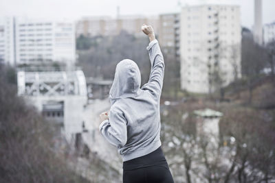 Rear view of sporty woman celebrating success