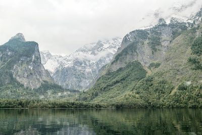 Scenic view of lake and mountains against sky