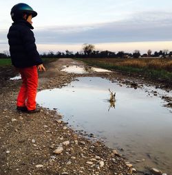 Man standing in water against sky