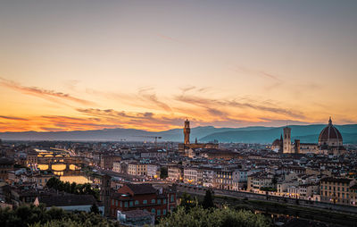High angle view of illuminated buildings against sky during sunset