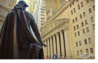 Low angle view of statue against buildings in city