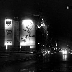 Illuminated road in city at night