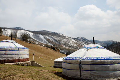 Tent on snow covered field against sky