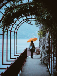 Rear view of woman walking on rainy day