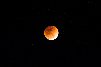 Low angle view of moon against clear sky at night