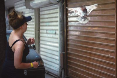 Rear view of woman looking at bird