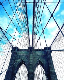 Low angle view of bridge against cloudy sky