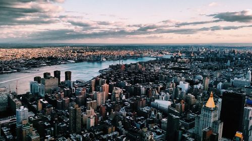 High angle view of cityscape against cloudy sky