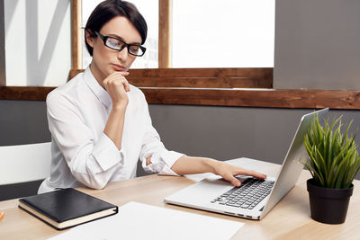 Woman using laptop on table