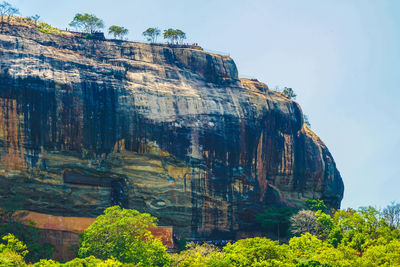 Low angle view of rock formations against sky