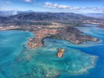 Aerial view of sea and mountains against sky