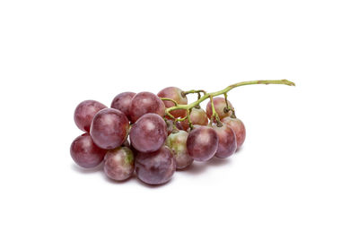 Close-up of grapes over white background