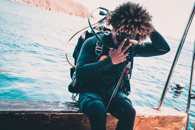 Man photographing at sea shore