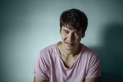 Portrait of young man against white background