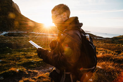 Man photographing at sunset