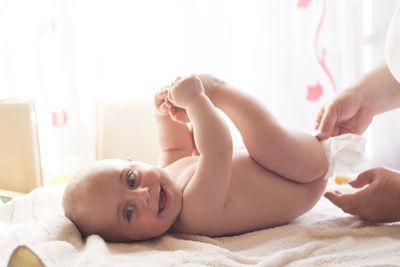 Portrait of woman lying on bed at home
