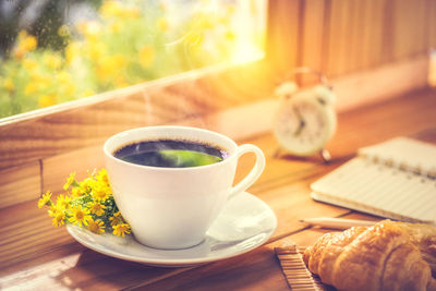 Close-up of cup and coffee on table