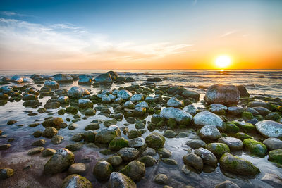 Close-up of sea against sky at sunset