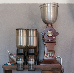 Close-up of coffee cup on table against wall