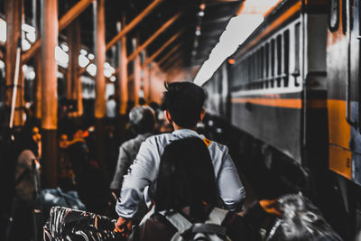 Rear view of man standing on train