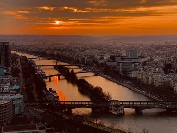 High angle view of bridge over river by buildings in city