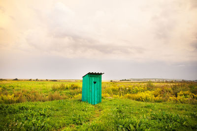 Built structure on field against sky