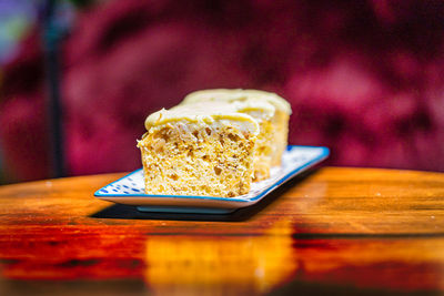 Slices of carrot cake in a plate on a wooden a table