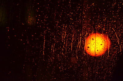 Close-up of illuminated light over black background