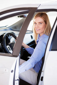 Close-up portrait of woman sitting car