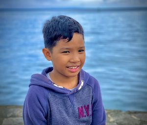 Portrait of boy smiling in sea