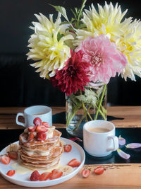 Close-up of pink flower vase on table