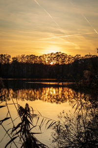 Scenic view of lake against sky during sunset