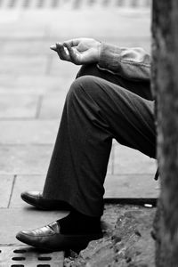 A well dressed gentleman asking for money on the street.