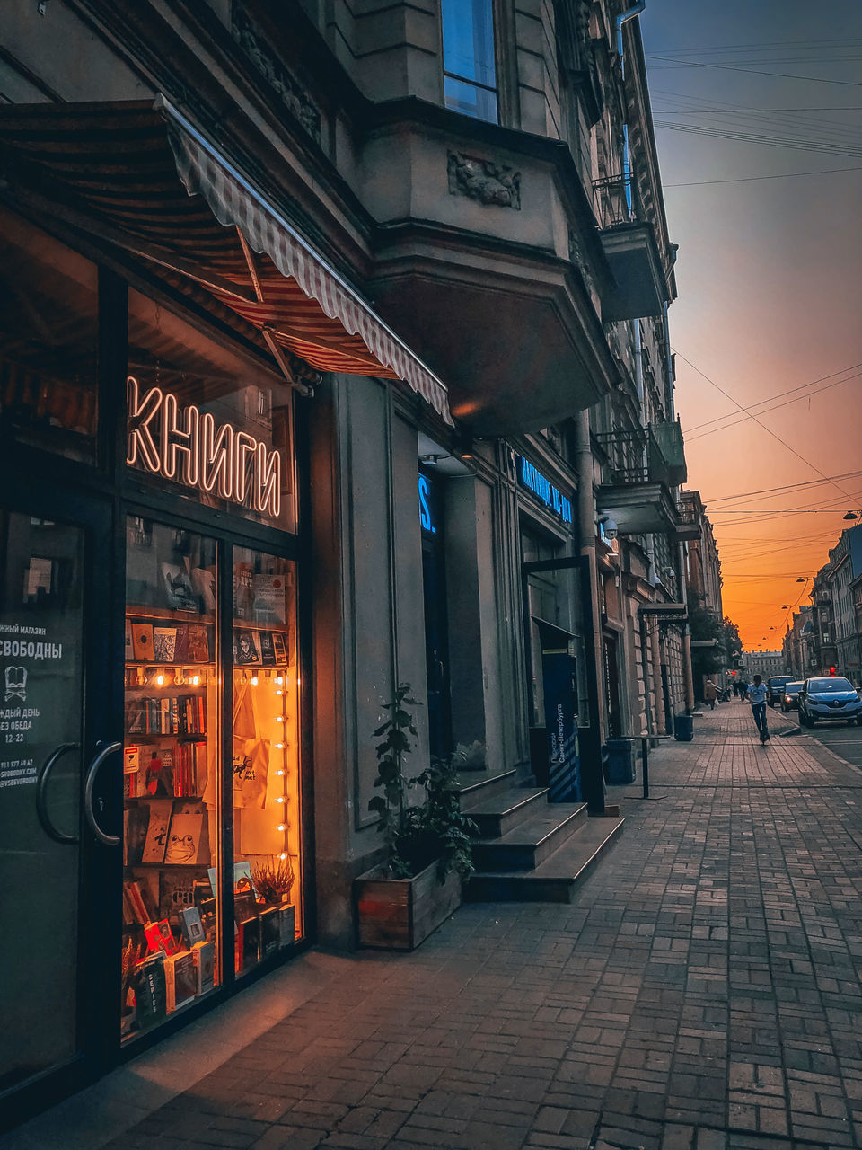 ILLUMINATED STREET AMIDST BUILDINGS