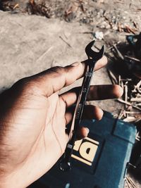 High angle view of hand holding camera