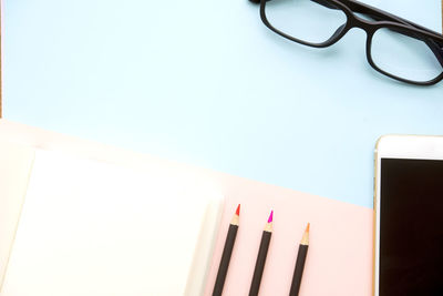 Close-up of eyeglasses on table against white background