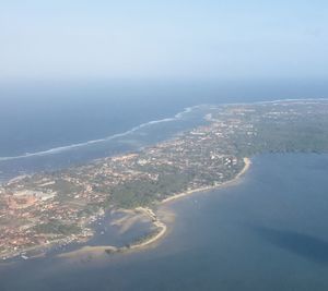 Aerial view of city and sea against sky