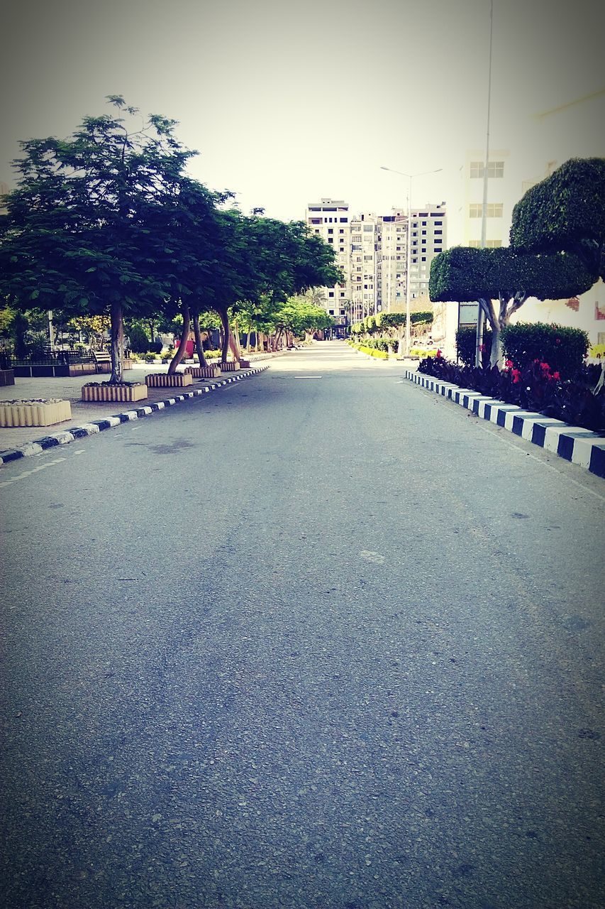 ROAD BY BUILDINGS AGAINST SKY