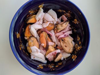 Mix of seafood in a bowl close up photo top view