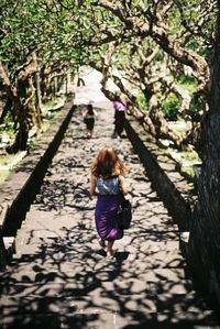 Rear view of women walking on walkway